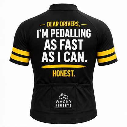 Black short-sleeve cycling jersey shown from the back with bold white and yellow text reading 'DEAR DRIVERS, I'M PEDALLING AS FAST AS I CAN. HONEST.