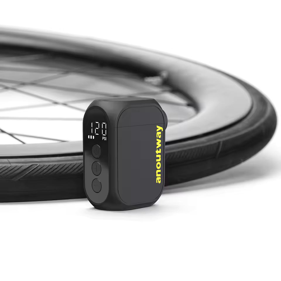 Digital tire pressure monitor with bicycle wheel in the background