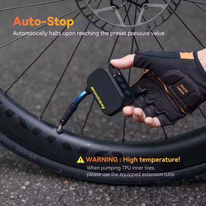 Hand using a bicycle air pump with 'Auto-Stop' feature and warning label on a tire.