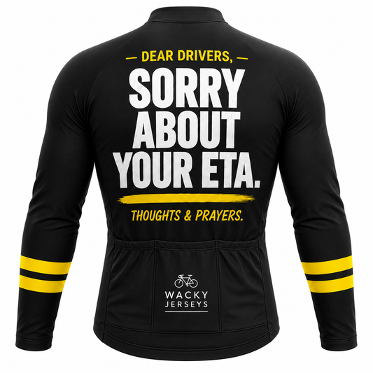 Black long-sleeve cycling jersey shown from the back with bold white and yellow text reading 'DEAR DRIVERS, SORRY ABOUT YOUR ETA. THOUGHTS & PRAYINGS.