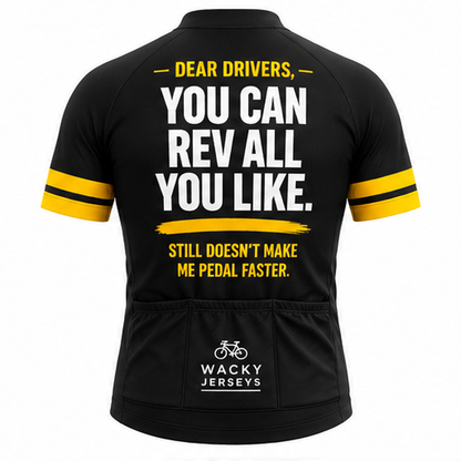 Black short-sleeve cycling jersey shown from the back with bold white and yellow text reading 'DEAR DRIVERS, YOU CAN REV ALL YOU LIKE. STILL DOESN'T MAKE ME PEDAL FASTER.